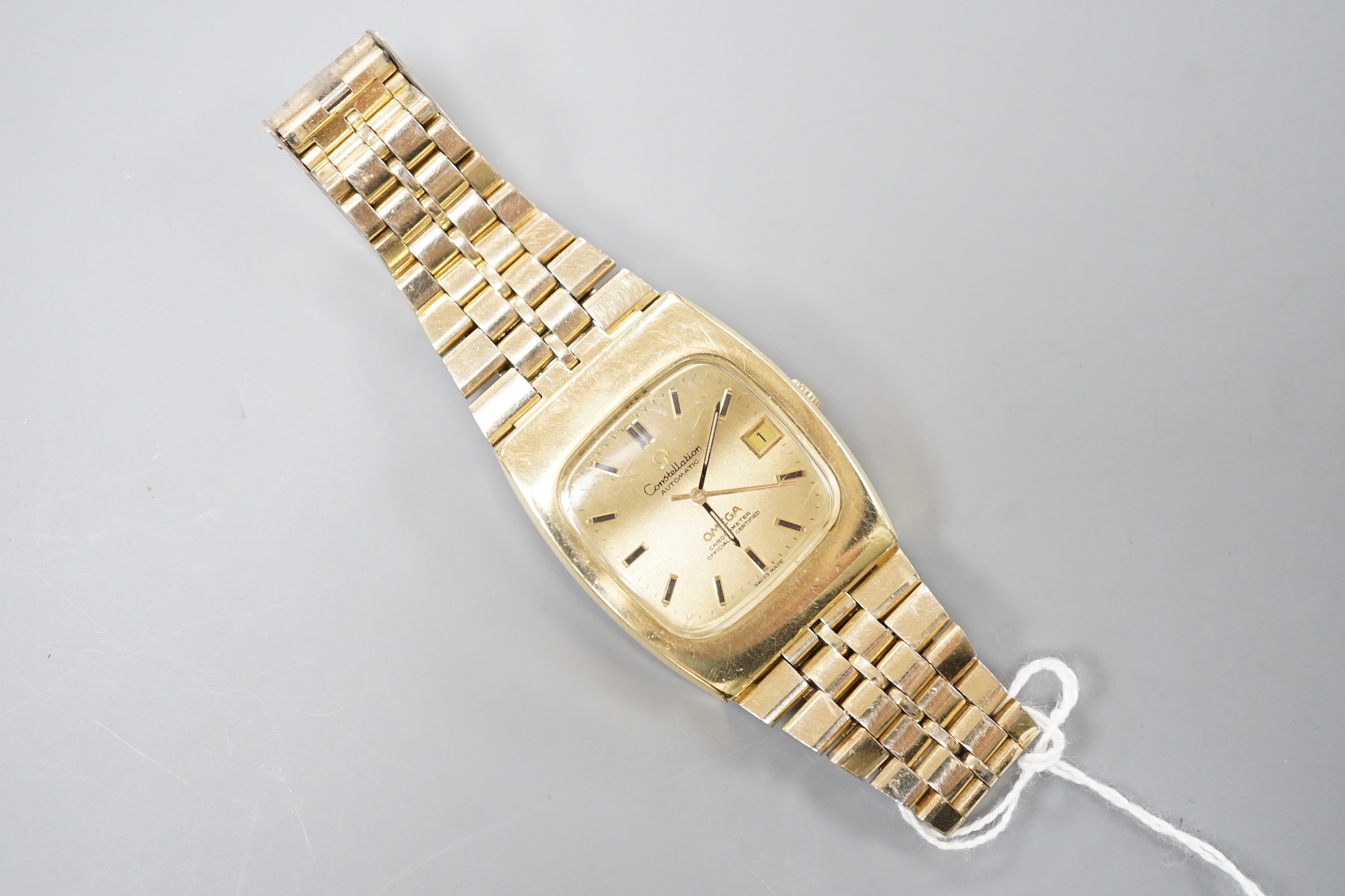 A gentleman's gold plated Omega Constellation Automatic wrist watch, on a gold plated Omega bracelet, case diameter 35mm, with date aperture, no box or papers.